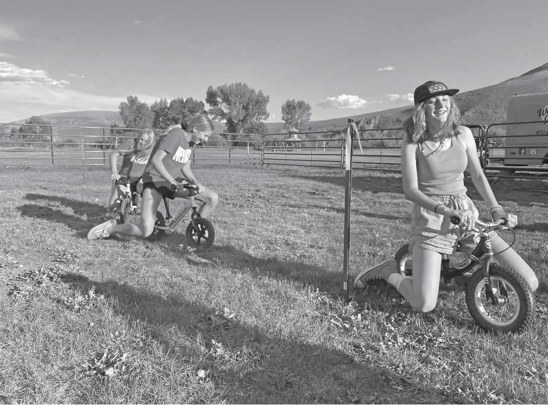 Kids in a stryder race at the 2022 Grits Guts and Gals Party