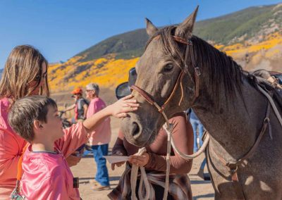 Volunteers and horses ready to ride.