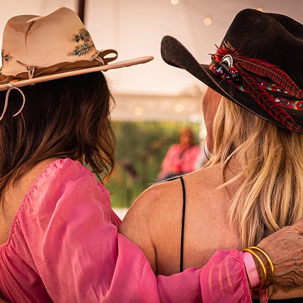 Two women in cowboy hats at a Gunnison Tough Event.