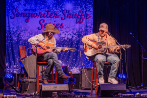 Dean Dillon and Ernest playing and singing onstage.