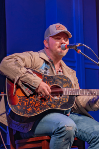 Ernest singing and playing his guitar.